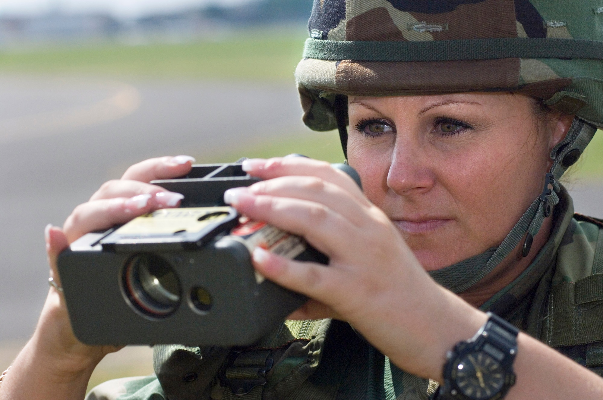 Tech. Sgt. Gina Faulds prepares to measure the line of visibility during field training at Wiesbaden Army Airfield, Germany, June 21. Sergeant Faulds, of Chino, Calif., is a battle weather forecaster and the NCO in charge of the 7th Weather Squadron's Detachment 6. (U.S. Air Force photo/Master Sgt. John E. Lasky)