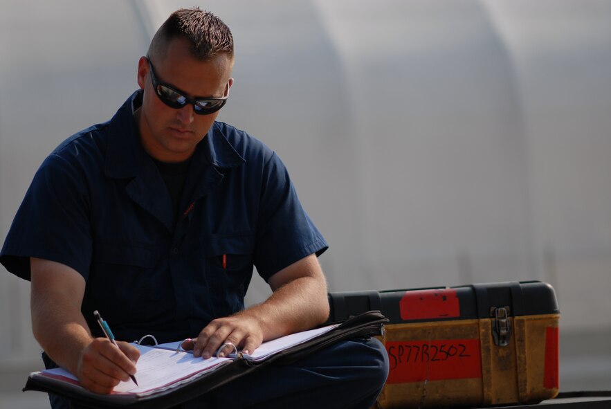 Staff Sgt. Brian Gaylor, 77th Fighter Squadron crew chief, anotates maintenance forms after launching an F-16 in support of Operation Dynamic Weasel June 29. Operation Dynamic Weasel is a multi-aircraft exercise imitating combat operations currently taking place in Southwest Asia. (U.S. Air Force photo/Tech. Sgt. James Arrowood) 
