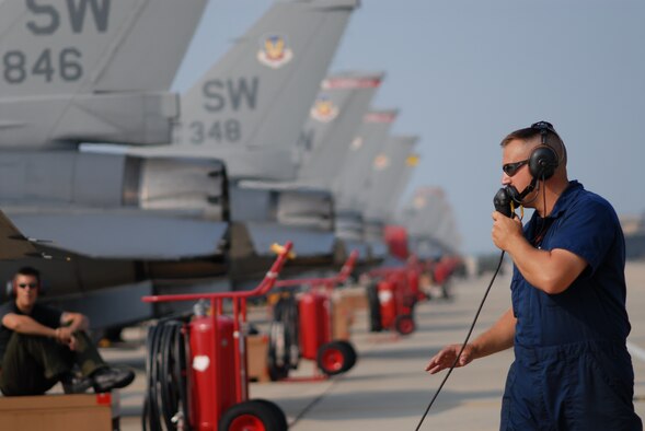 SSgt Brian Gaylor, 77th Fighter Squadron crew chief, pre-flights an F-16 prior to launch in support of Operation DYNAMIC WEASEL June 29, 2006 at Shaw AFB, South Carolina. Operation DYNAMIC WEASEL is a multi-aircraft exercise imitating combat operations currently taking place in Southeast Asia. (U.S. Air Force Photo/Tech. Sgt. James Arrowood)