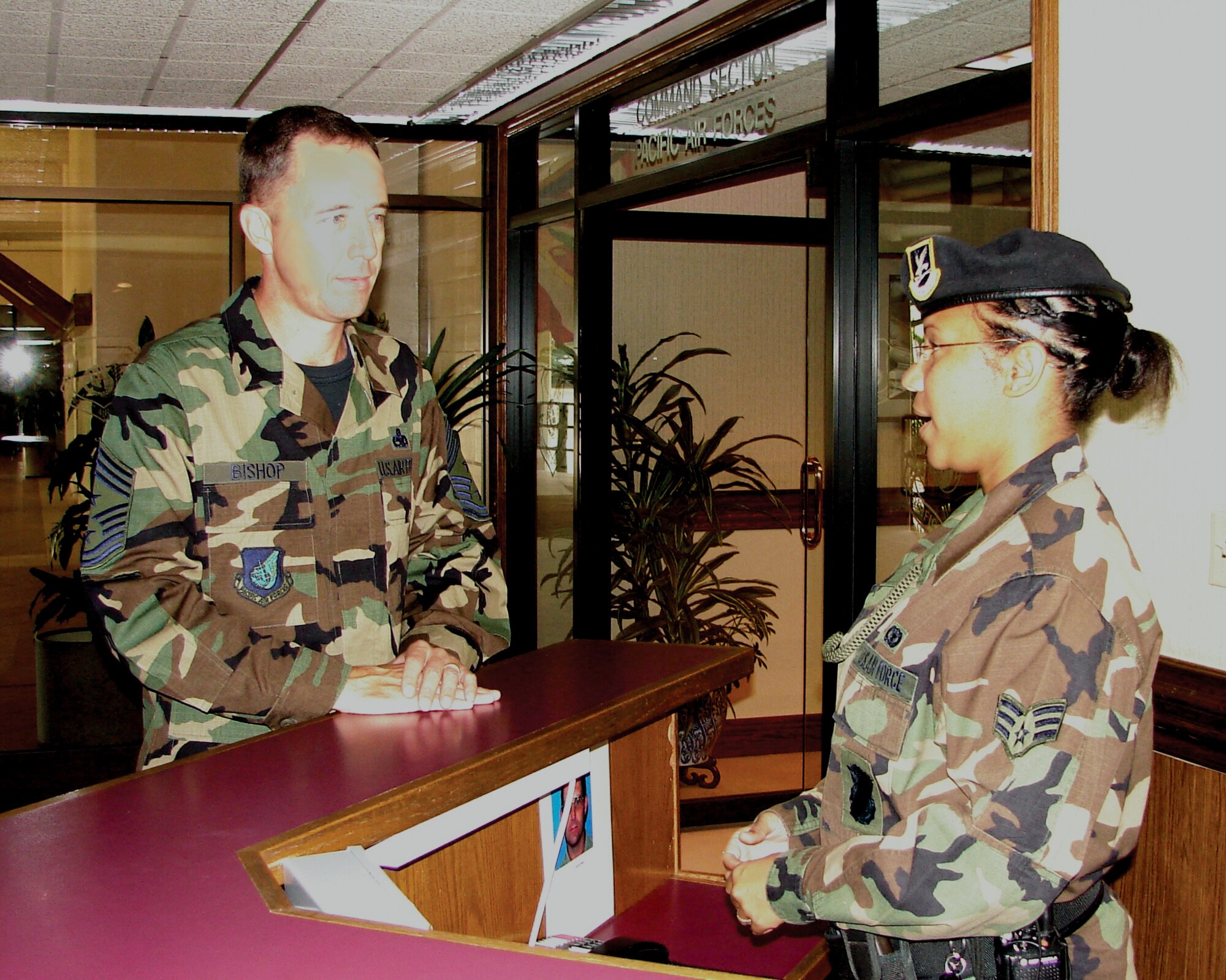 HICKAM AIR FORCE BASE, Hawaii -- Chief Master Sgt. Anthony Bishop discusses security procedures with Senior Airman Jasmine Frank, 15 Airlift Wing, Security Forces. (Air Force photo by Capt.  Allison Farabaugh)
