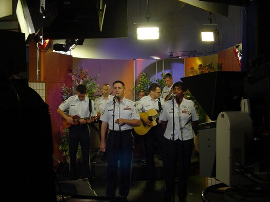HONOLULU, Hawaii -- Members of the Pacific Air Forces Band, Hana Hou (Hawaiin for One More Time) perform patriotic music  July 4th on Honolulu TV station KHNL, the local  NBC affiliate.  The band performed during three separate live segments on  KHNL's morning program and talked with morning host, Marvin Buenconsejo, about the importance of the band to the morale and readiness of Airmen, the total force nature of our military and the shows they performed on Independence Day to include two performances at Hickam Harbor.  (U. S. Air Force photo by CMSgt Sharon Johnson)