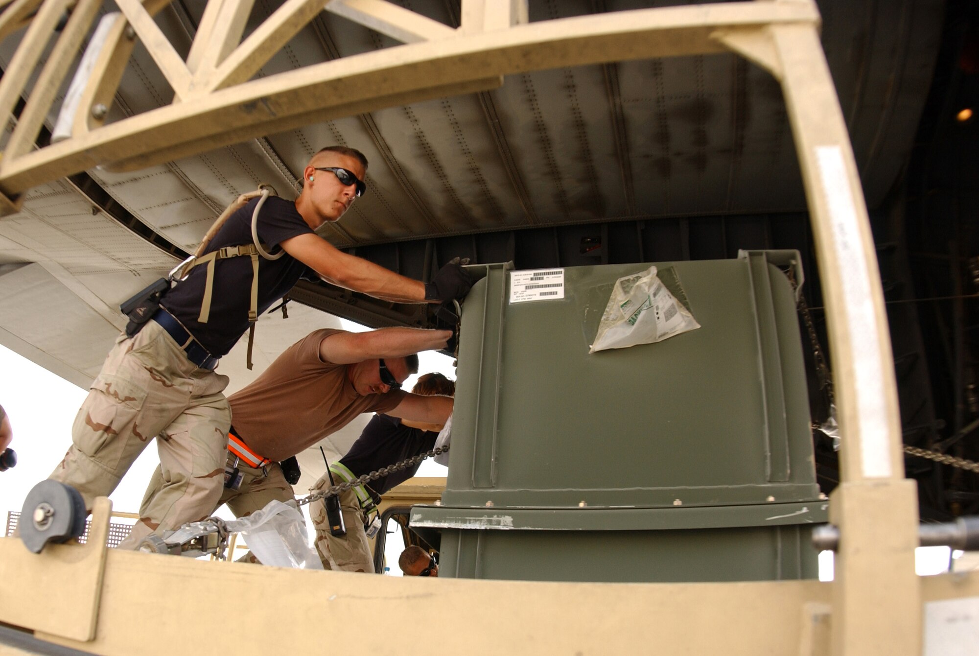 Airman 1st Class Jeff Boutin and fellow aerial porters load a C-130 Hercules at Balad Air Base, Iraq, on Tuesday, July 4. More than 12,000 tons of cargo were moved by the squadron in June. (U.S. Air Force photo/Senior Airman James Croxon) 
