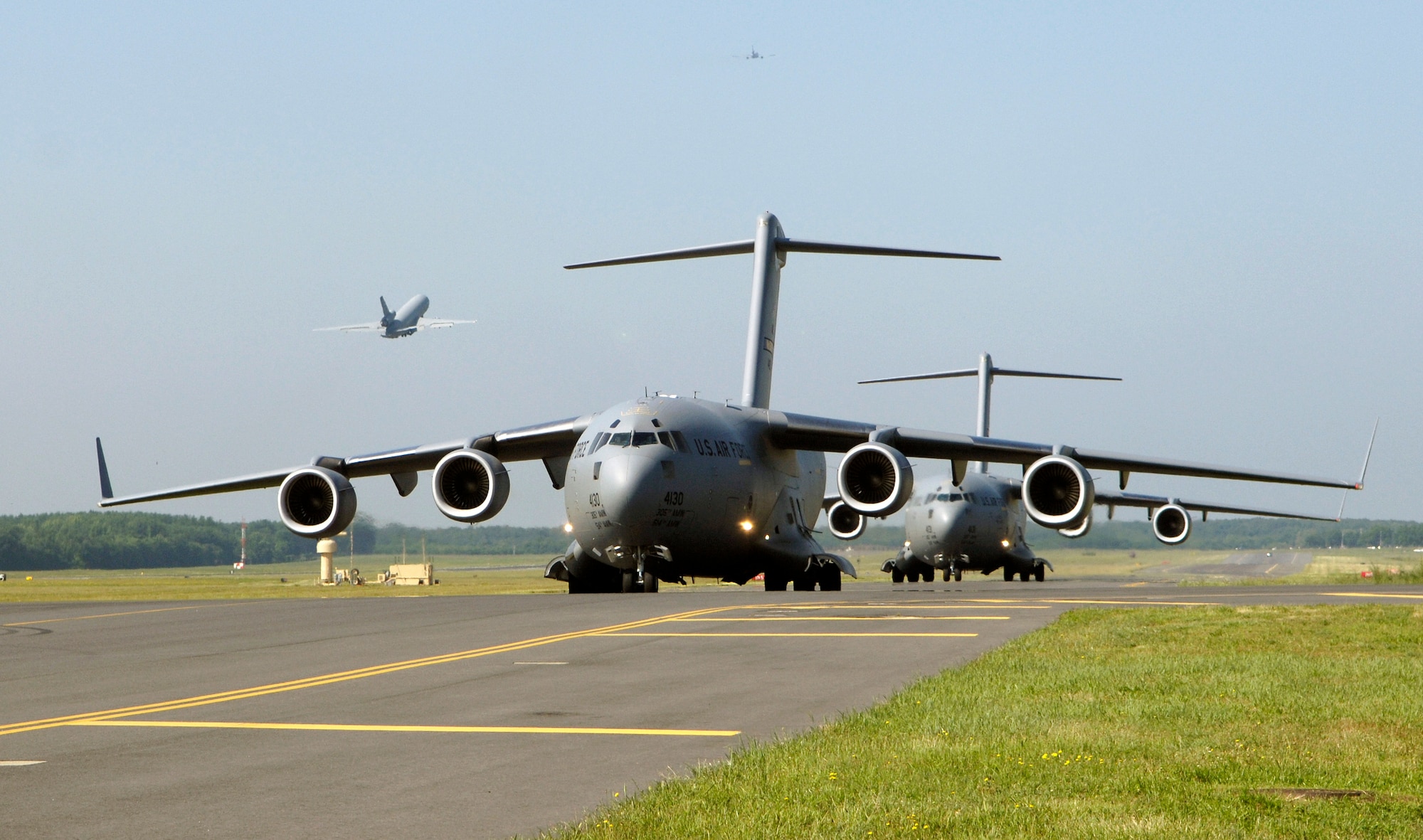 KC-10 Extenders and C-17 Globemaster IIIs launch from the McGuire Air Force Base, N.J., flightline during the emergency response exercise Elephant Walk. This is the first time C-17s and KC-10s have been paired in an exercise. Sixteen aircraft launched from McGuire on Friday, June 30, as part of the exercise. (U.S. Air Force photo/Brian Dyjak)

