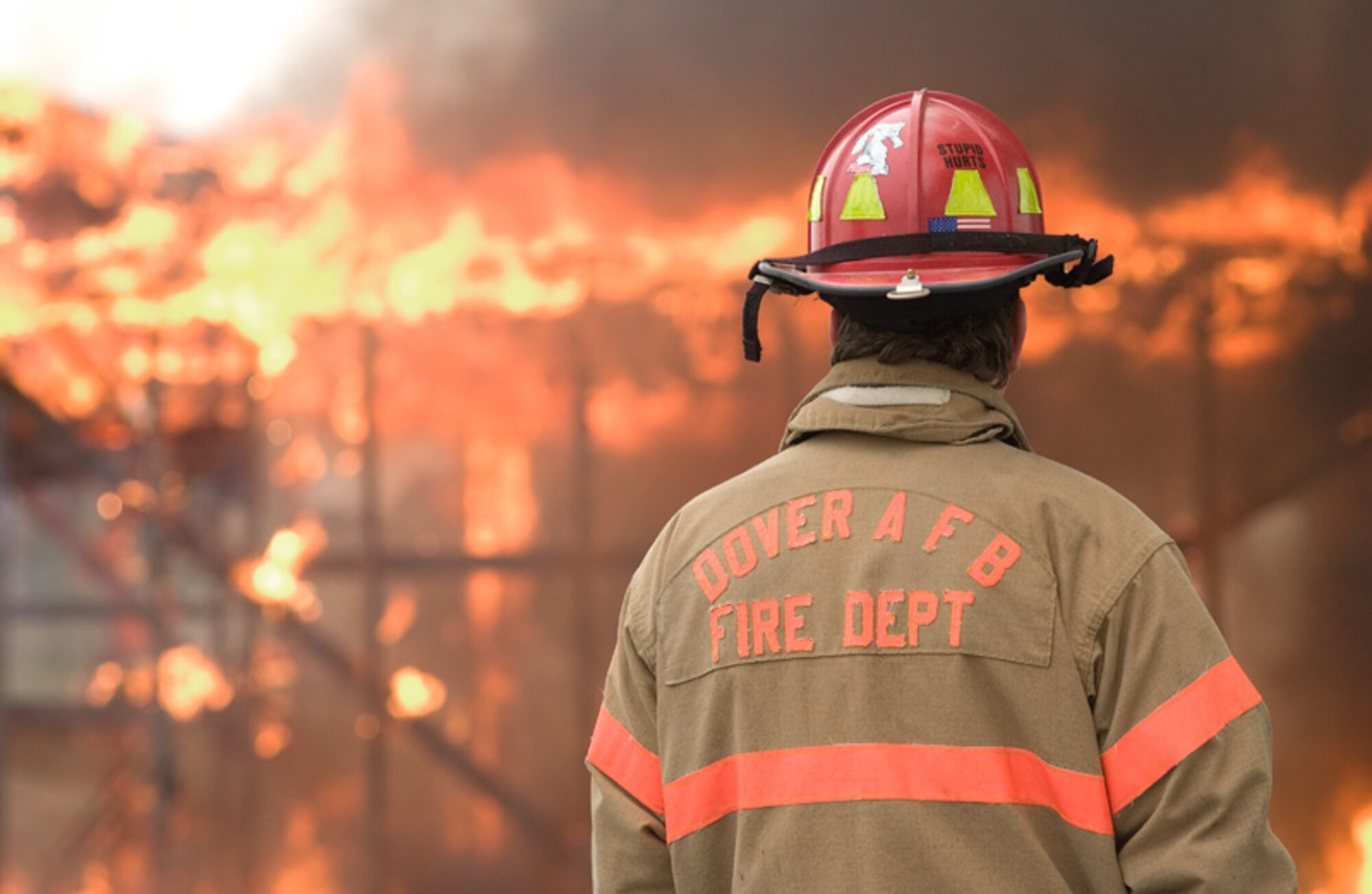 DOVER AIR FORCE BASE, Del. -- Jeff McCombs, 436th Civil Engineer Squadron firefighter, monitors the burning of Building 480, the old Airman Leadership School facility, at Dover Air Force Base Feb. 20. From Feb. 20 – 23, the base fire department, along with local civilian fire departments throughout Delaware, torched different rooms inside the building to train and refresh firefighters on building-entry tactics and blaze-extinguishing methods. More than 100 firefighters between the base and local departments received valuable training participating in the burn. The fire department burned the building completely to the ground, which caused a smoke plume that could be seen from more than 10 miles away.