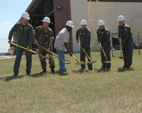 Col. Ozzie Gorbitz, 917th Operations Group commander, Navy Lt. Scott Gustin, Navy resident officer in charge of construction, Sandino Thompson, Sauer Construction project manager, Lt. Col. Tim Mers, 93rd Bomb Squadron chief B-52 navigator, Col. Daniel Charchian, 2nd Bomb Wing commander, and Brig. Gen. (S) Bob Tarter, 917th Wing commander, break ground for the new 93rd Operations building Thursday, June 29. The new 20,293 square-foot building will house mission planning, command offices, aircrew life support and training, an aircrew lounge, toilet and shower facilities, multiple briefing rooms, a 100-seat auditorium and a 112-car parking area. Its estimated date of completion is September 2007. (U.S. Air Force photo/Tech. Sgt. Sherri Savant)