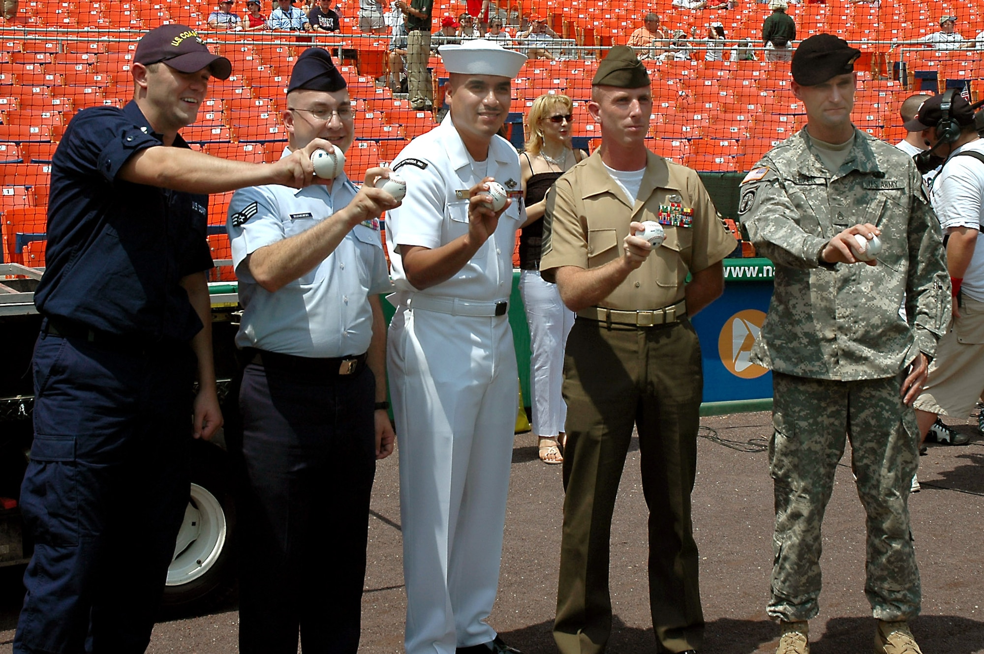 (From left) Coast Guard Petty Officer 2nd Class Seth Cockram, Headquarters U.S. Coast Guard; Senior Airman Joseph Buzanowski, Detachment 16, Air Force News Agency, Washington, D.C.; Navy Hospital Corpsman 2nd Class Roberto Medrano, National Naval Medical Center, Bethesda, Md.; Marine Corps First Sgt. Bobby Barnett, Henderson Hall Company, Washington, D.C.; and Army Staff Sgt. Jody Belzer, 289th Military Police Company, Fort Meyer, Va., were all given the opportunity to throw out a ceremonial "first pitch" before the Washington Nationals game against the Tampa Bay Devil Rays on Sunday, July 2. The event was part of the July Fourth weekend's "Military Appreciation Day" activities at Robert F. Kennedy Memorial Stadium. (U.S. Air Force photo/Staff Sgt. C. Todd Lopez)