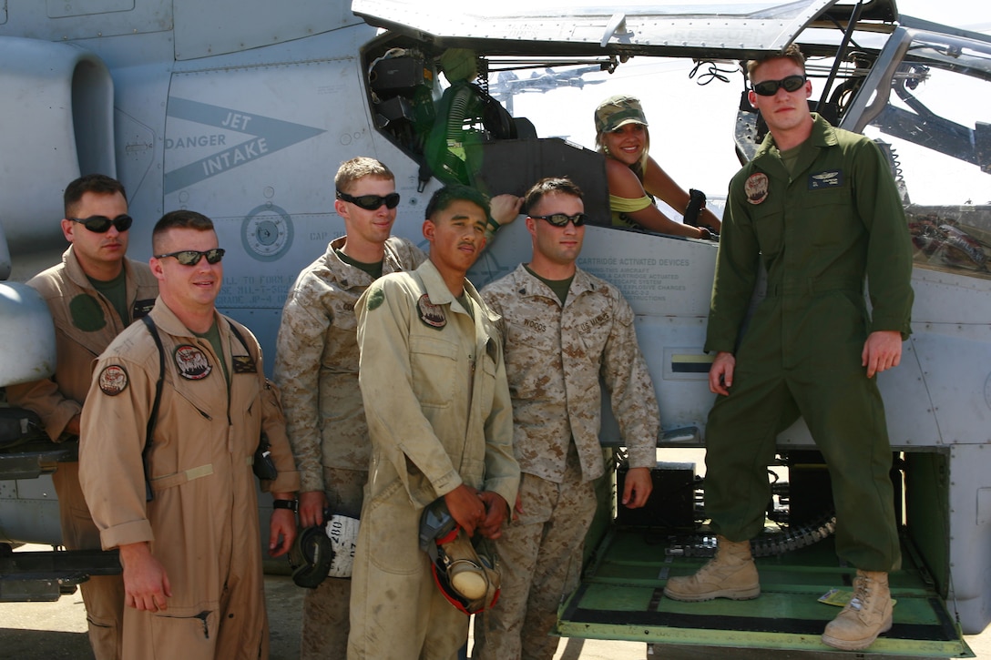 Jessica Sierra poses with several Marines from Marine Light Attack Helicopter Squadron 269 July 6 at Al Asad, Iraq. Sierra was a finalist on American Idol and toured Iraq for 10 days to show her support for deployed service members. During her visit to the squadron she posed for photos with Marines and learned about the squadron's job in Iraq. HMLA-269 operates under Marine Aircraft Group 16 (Reinforced), 3rd Marine Aircraft Wing.