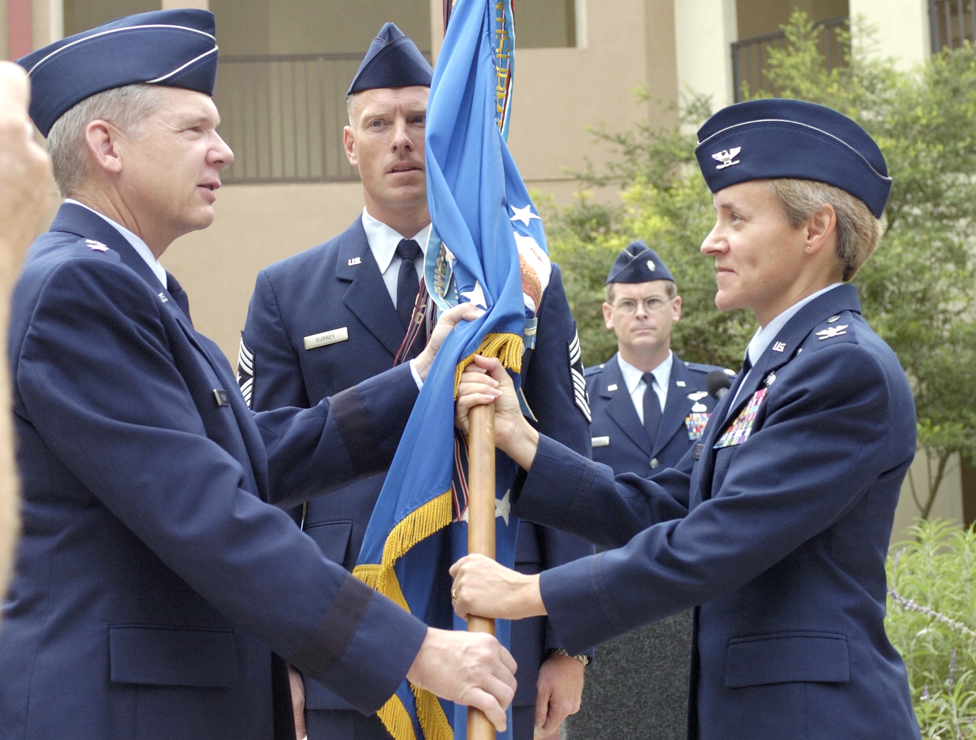 Lt. Gen. Robert J. Elder presents Col. Kathryn Gauthier with the 67th Network Warfare Wing's guidon during the unit's redesignation ceremony at Lackland Air Force Base, Texas, on Friday, July 7. General Elder is 8th Air Force and Air Force Network Operations commander. (U.S. Air Force photo/Master Sgt. Jack Braden)

