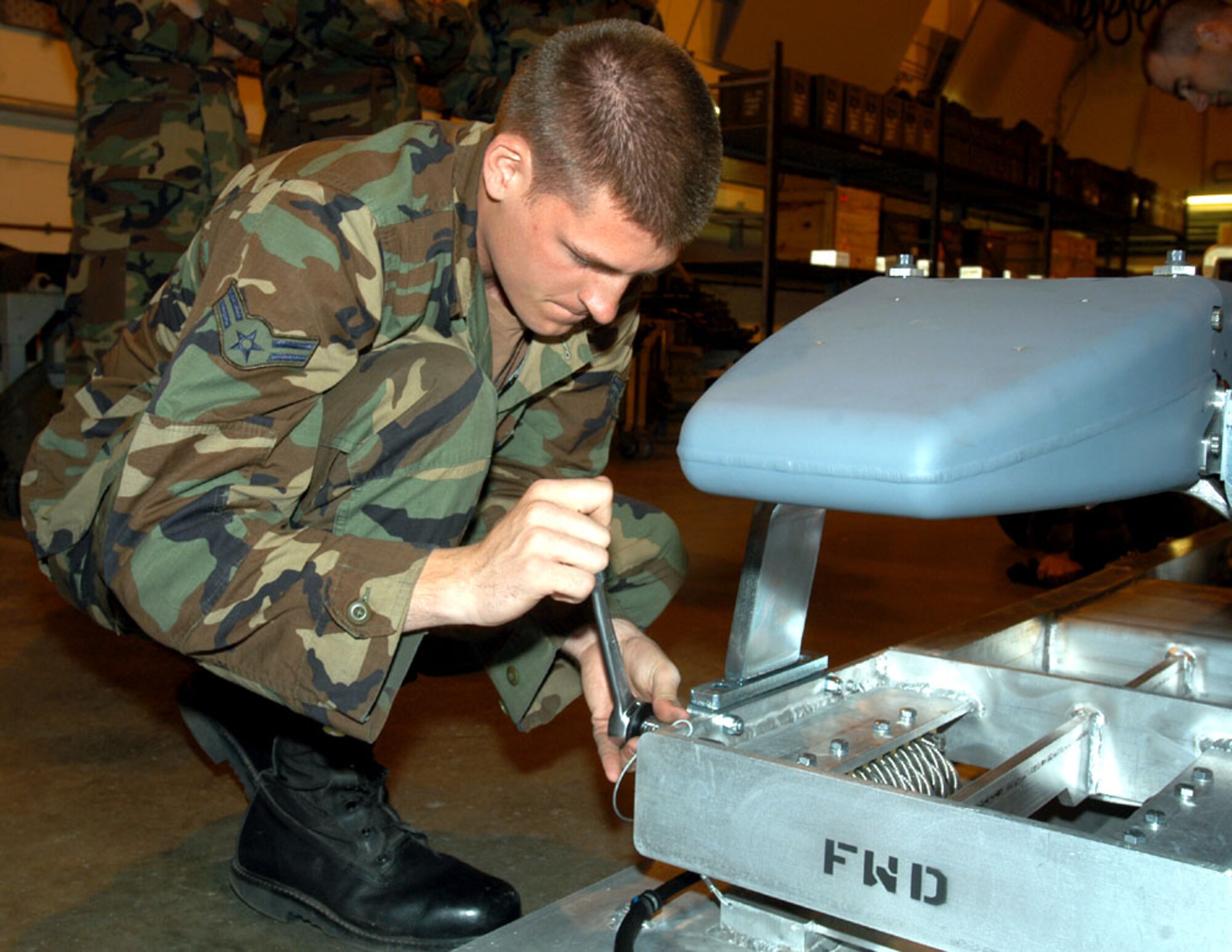 Airman 1st Class Mark Sturtevant trains on the new munitions release unit at Royal Air Force Lakenheath, England. This is the first time Airmen conducted operational training on the munition for their scheduled deployment in September. Airman Sturtevant is assigned to the 48th Munitions Squadron. (U.S. Air Force photo)
