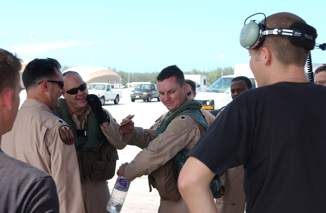 Lt. Col. Jeff Roetzel, 9th Expeditionary Bomb Squadron, places a 4,000 hour patch on his uniform just after completing a recent Operation Enduring Freedom combat mission.  Colonel Roetzel is the first pilot to ever reach 4,000 flying hours in a B-1B.   (Photo by Staff Sgt. Patrick Mitchell)