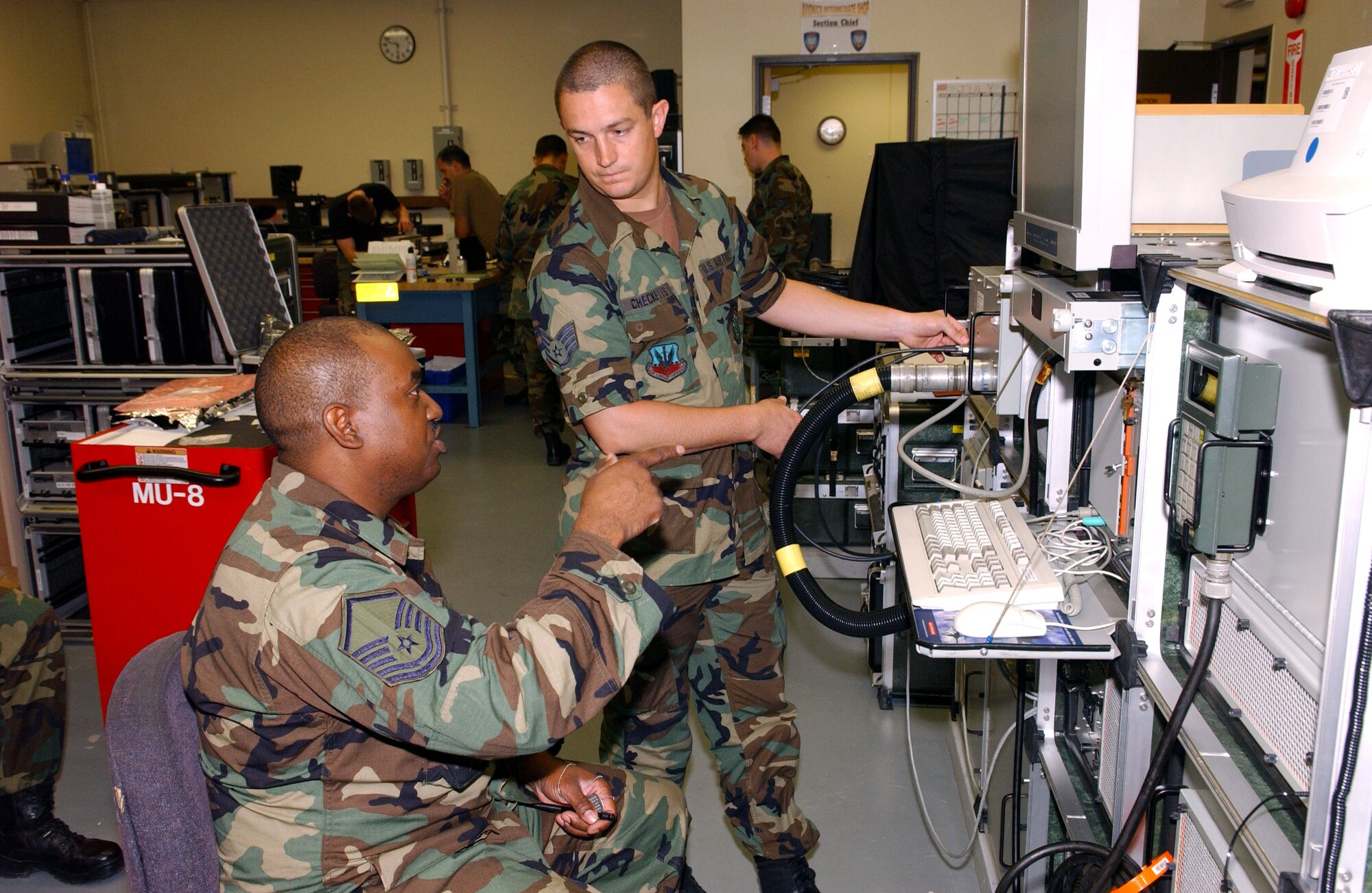 Master Sgt. David Ligon (seated) and Staff Sgt. Robert Checketts run calibration tests in the avionics intermediate shop at Kunsan Air Base, South Korea, on Thursday, July 6. Sergeant Ligon is assigned to the Colorado Air National Guard's 140th Fighter Wing. Sergeant Checketts is assigned to Kunsan's 8th Maintenance Squadron. (U.S. Air Force photo/Tech. Sgt. Erik Gudmundson) 
