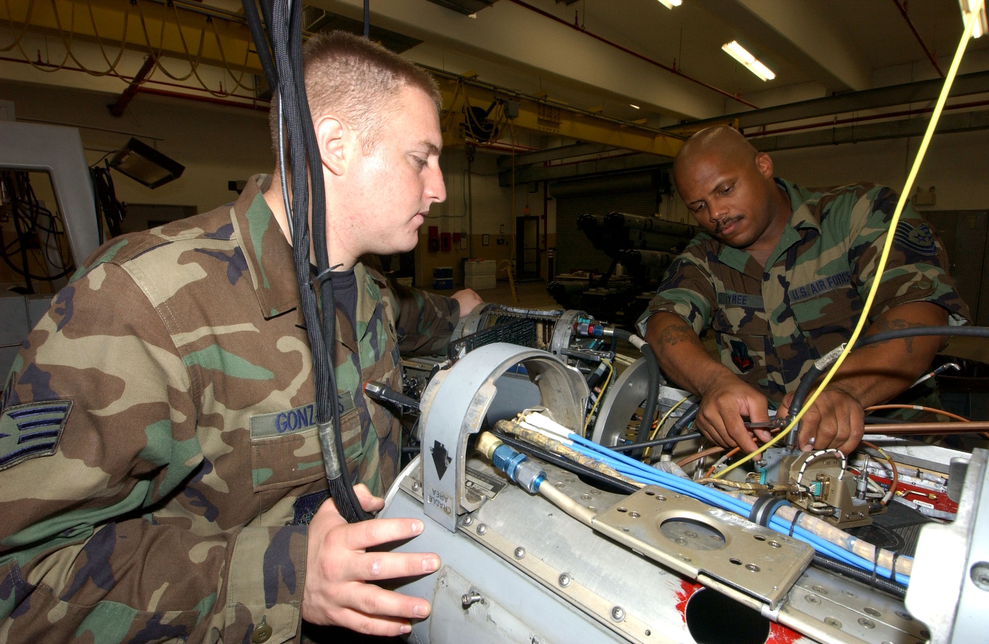 Staff Sgt. Hector Gonzales (left) works with Tech. Sgt. Edward Tyree on an electronic warfare pod at Kunsan Air Base, South Korea, on Thursday, July 6. Sergeant Gonzales is with Kunsan's 8th Maintenance Squadron. Sergeant Gonzales is with the New Mexico Air National Guard's 150th Fighter Wing. (U.S. Air Force photo/Tech. Sgt. Erik Gudmundson) 
