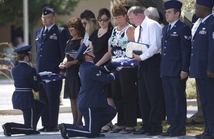 Two members of the Nellis Honor Guard present American flags to Senior Airman Danny Wynn’s mother, Pamela Dahman, and father, Danny Wynn, at the Base Chapel June 29. Airman Wynn was a dedicated crew chief with the 763rd Maintenance Squadron who died June 20 while driving in Winchester, Ill., to attend his father’s wedding. He had returned two weeks prior from a deployment in support of Operation Iraqi Freedom. (U.S. Air Force Photo/Airman 1st Class Jason Huddleston)
