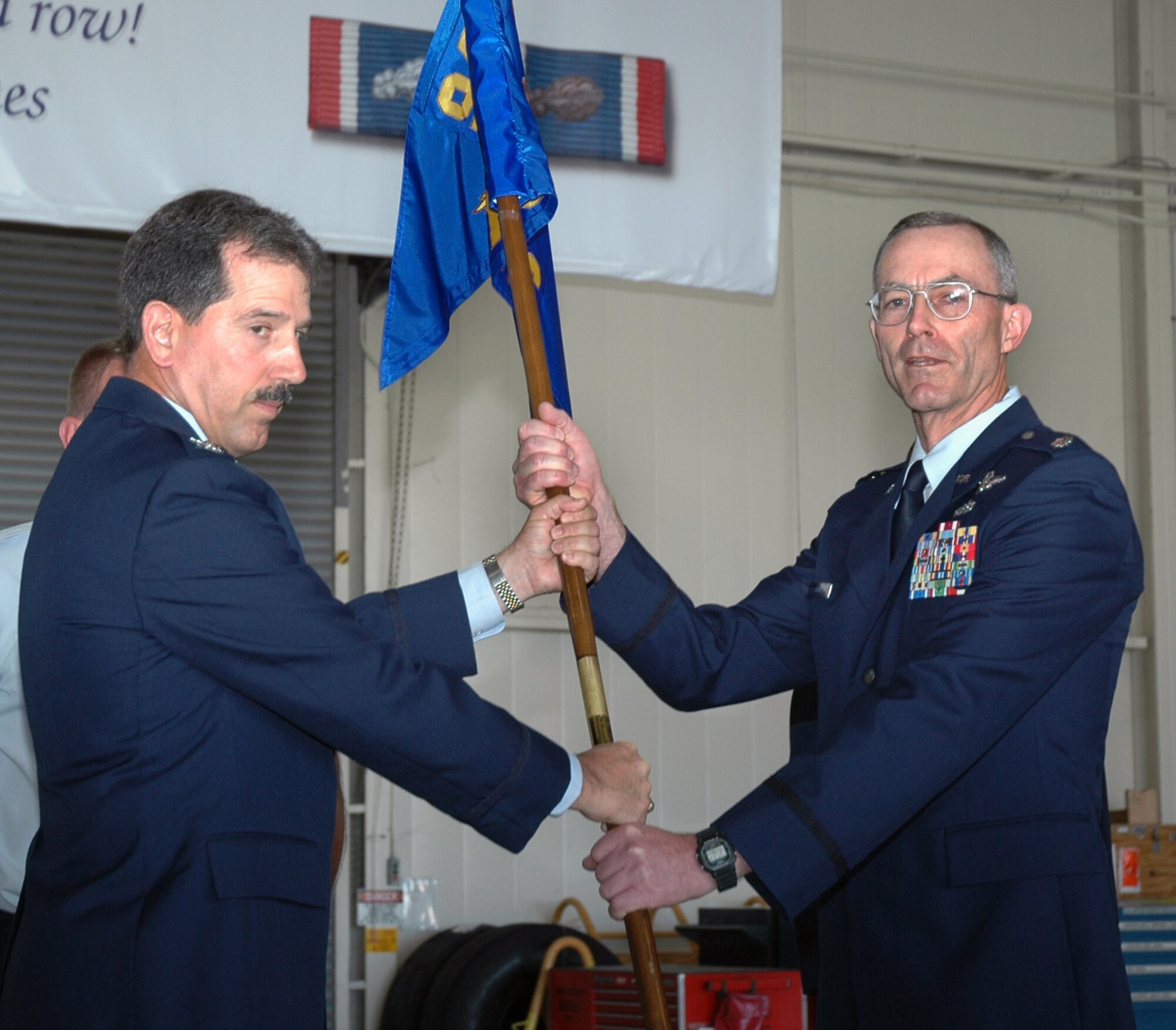 Air Force Reservist Lt. Col. Gregory Steuer (right) accepts command of the 940th Aircraft Maintenance Squadron from Col. Melvin Giddings, Jr., 940th Maintenance Group commander, during a ceremony June 10, 2006 at Beale Air Force Base, Calif.  (U.S. Air Force photo/Tech. Sgt. Brynna Bryant)