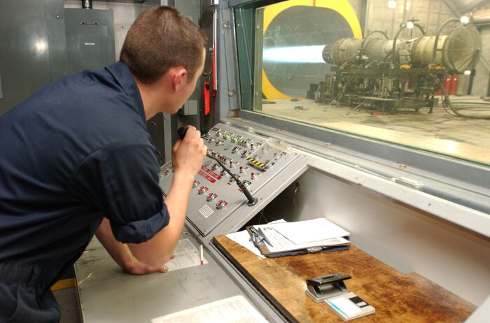 Senior Airman Charles Scaperotto, 57th Component Maintenance Squadron at Nellis Air Force Base, Nev., monitors an engine from the control booth during a full afterburner test. (U.S. Air Force Photo/Airman 1st Class Kasabyan Austin)