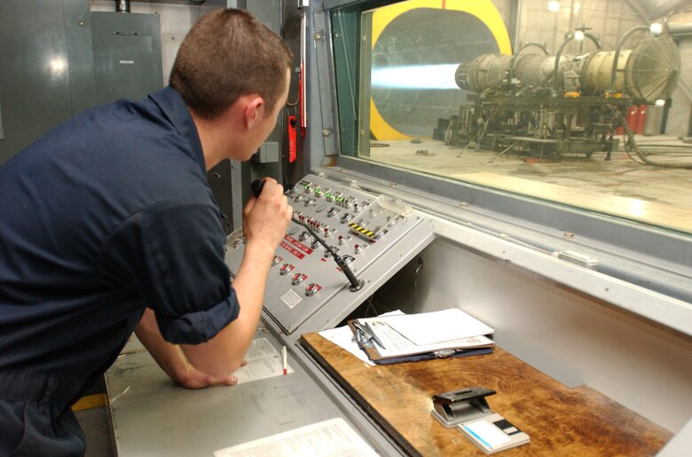 Senior Airman Charles Scaperotto, 57th Component Maintenance Squadron at Nellis Air Force Base, Nev., monitors an engine from the control booth during a full afterburner test. (U.S. Air Force Photo/Airman 1st Class Kasabyan Austin)