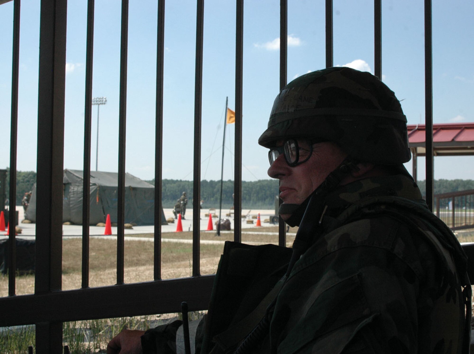 HUNTER ARMY AIRFIELD, Ga., - Master Sgt. Lyle Lane, 446th Airlift Control Flight at McChord Air Force Base, Wash., observes a foreign object damage team preparing the parking ramp for aircraft following a simulated attack here.  Members of the 446th Airlift Wing took part in an Air Mobility Command inspected operational readiness inspecdtion, along with the 62nd Airlift Wing at McChord, and the 319th Air Refueling Wing, Grand Forks, N.D., and the 944th Aeromedical Staging Squaron, Luke AFB, Ariz., June 11-18. (U.S. Air Force photo by Master Sgt. Tom Martin)
