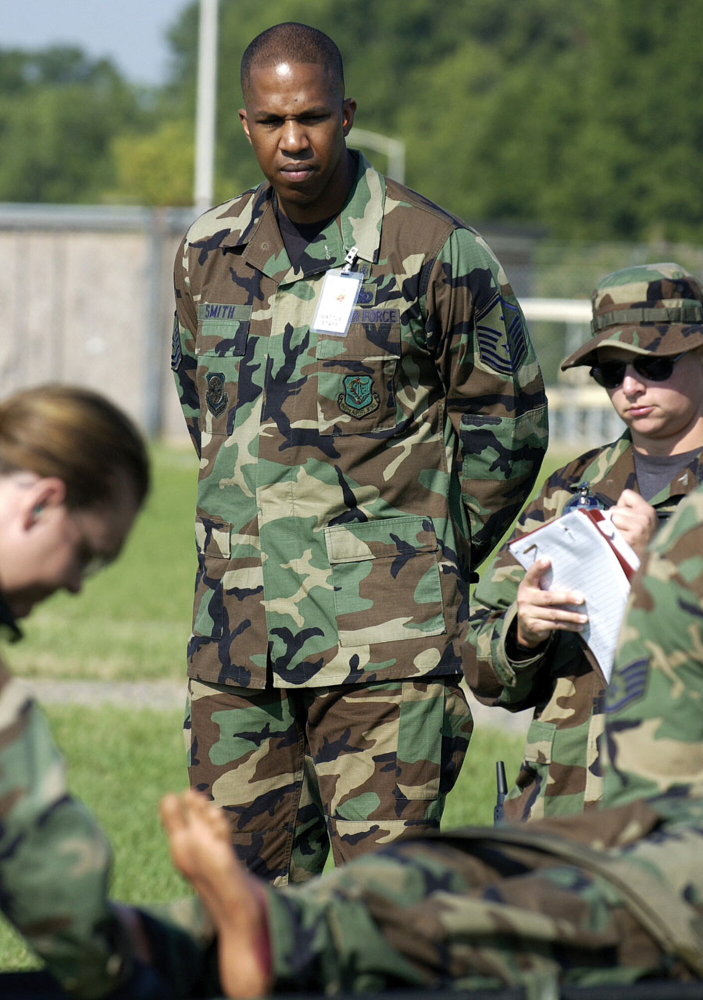 AUGUSTA, Ga., - Master Sgt.Theron Smith, 446th Aeromedical Evacuation Squadron, McChord Air Force Base, Wash., keeps a watchful eye over his Airmen as they perform a training scenario of patient evacuation at Augusta Regional Airport at Busch Field, Ga., one of the two sites for Golden Medic 2006.  (U.S. Air Force photo by SSgt Stephen Schester)