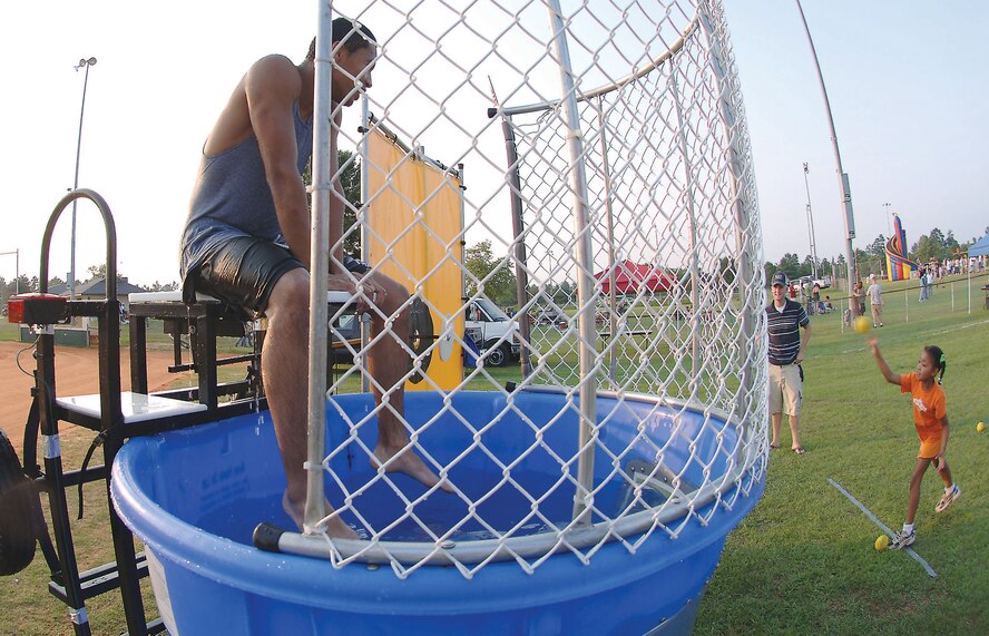 A soaked Airman 1st Class Waymon Brown, 20th Civil Engineer Squadron firefighter, waits to get dunked again.  (U.S. Air Force photo/Airman 1st Class Katherine Dodd)