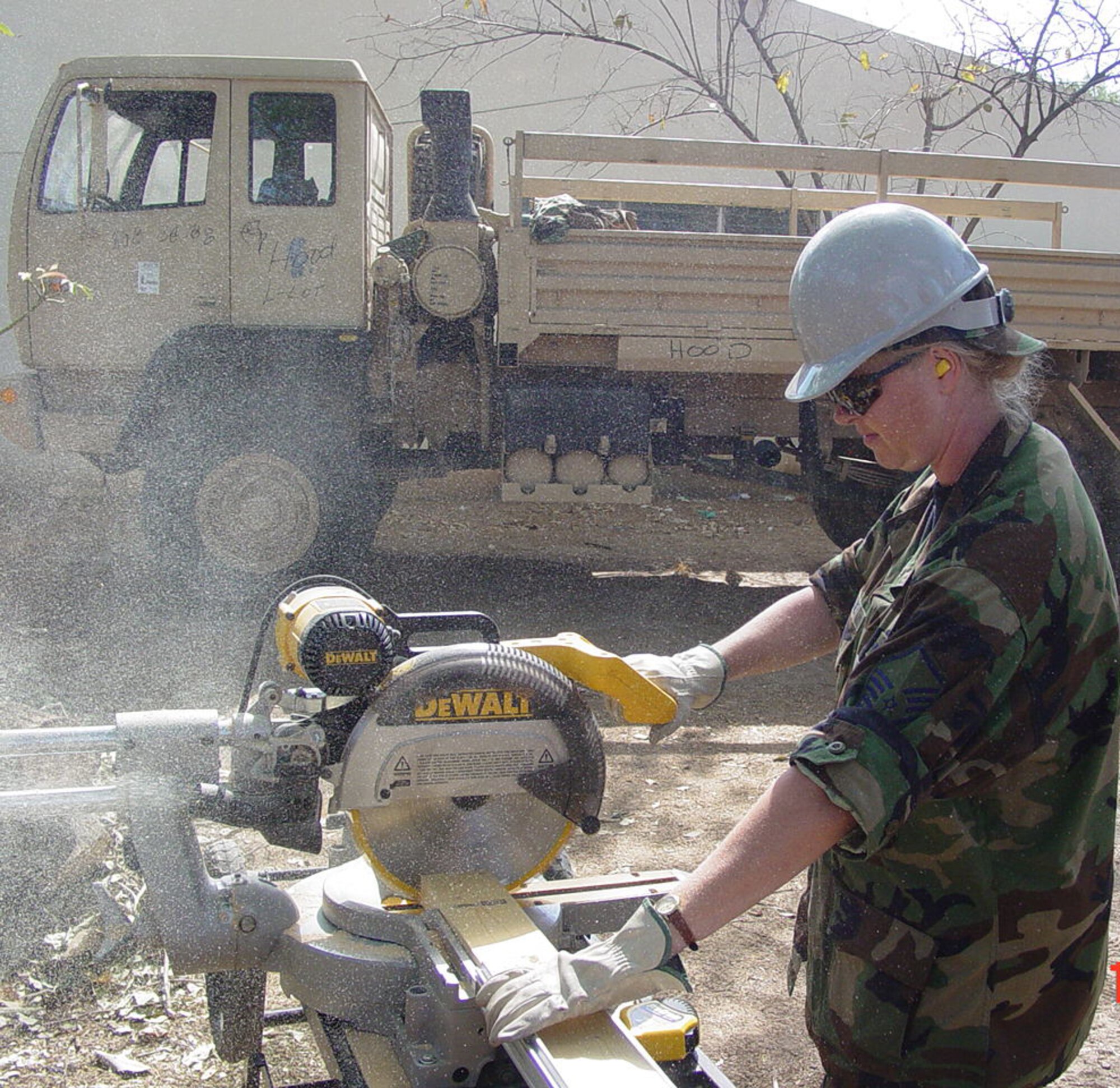 Master Sgt. Jill Loyle, 944th Civil Engineer Squadron structural supervisor, cuts lumber for a construction site during a humanitarian mission in El Salvador. (Courtesy photo)                