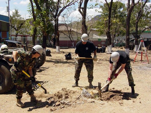 (Left to right) Maj. Hayley Wihongi, 944th Civil Engineer Squadron engineering officer; Staff Sgt. Kenneth Heng, 944th CES firefighter; and Senior Airman Robert Rodriguez, 944th CES utilities system journeyman, clear tree stumps during a humanitarian mission in El Salvador. (Courtesy photo)                              