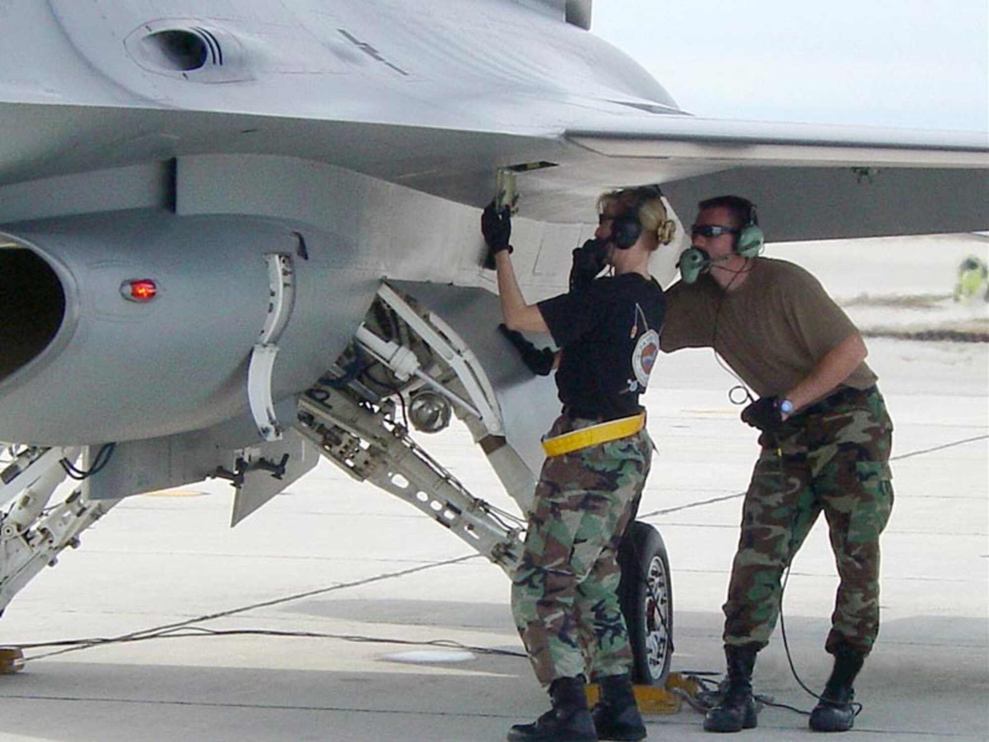 Lt. Col. Anne Gunter, 944th Maintenance Group executive officer, and Staff Sgt. Vance Hoffman, 944th Maintenance Squadron maintenance technician, inspect an access panel on a 944th Fighter Wing F-16. (Courtesy photo)                