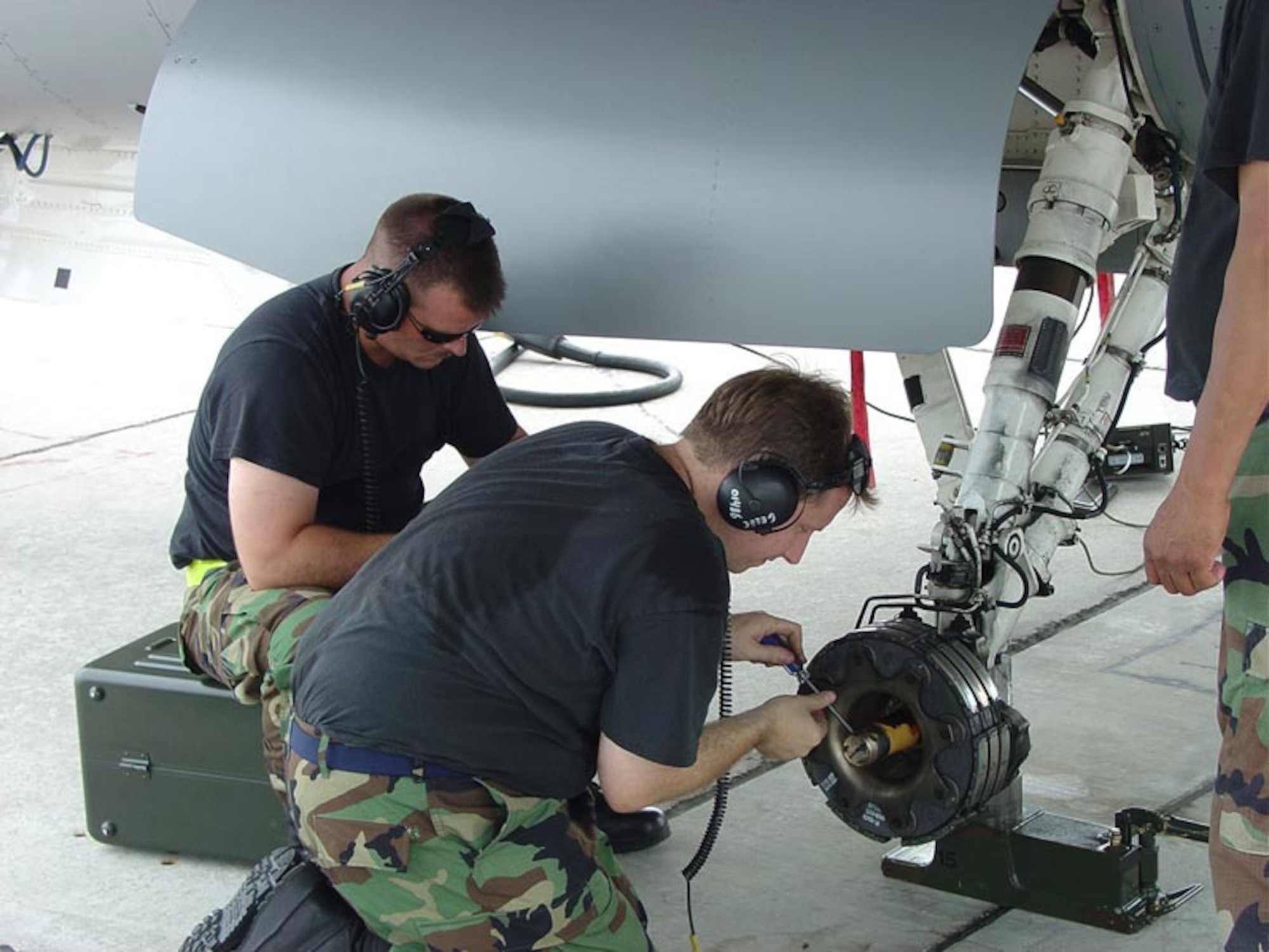 Staff Sgt. Adam Martin and Tech. Sgt. Krik Finkbeiner, 944th Maintenance Squadron members, perform maintenance on an F-16 wheel assembly. (Courtesy photo)                   