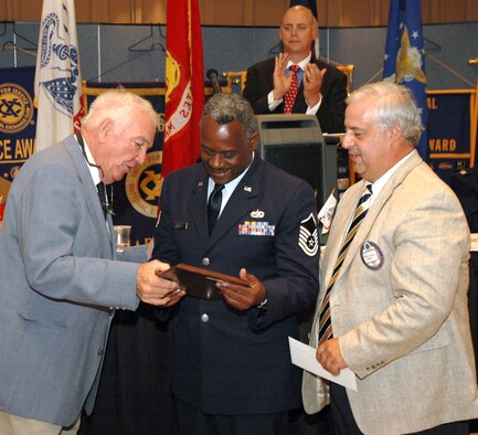 Rewarding smile: Master Sgt. Jariette Mace, 315th Maintenance Squadron, (center) smiles as he looks at his award while The Exchange Club of Charleston members look on. Sergeant Mace was named the club’s Reserve Airman of the Year. (Photo by Tech. Sgt. Mary Hinson)