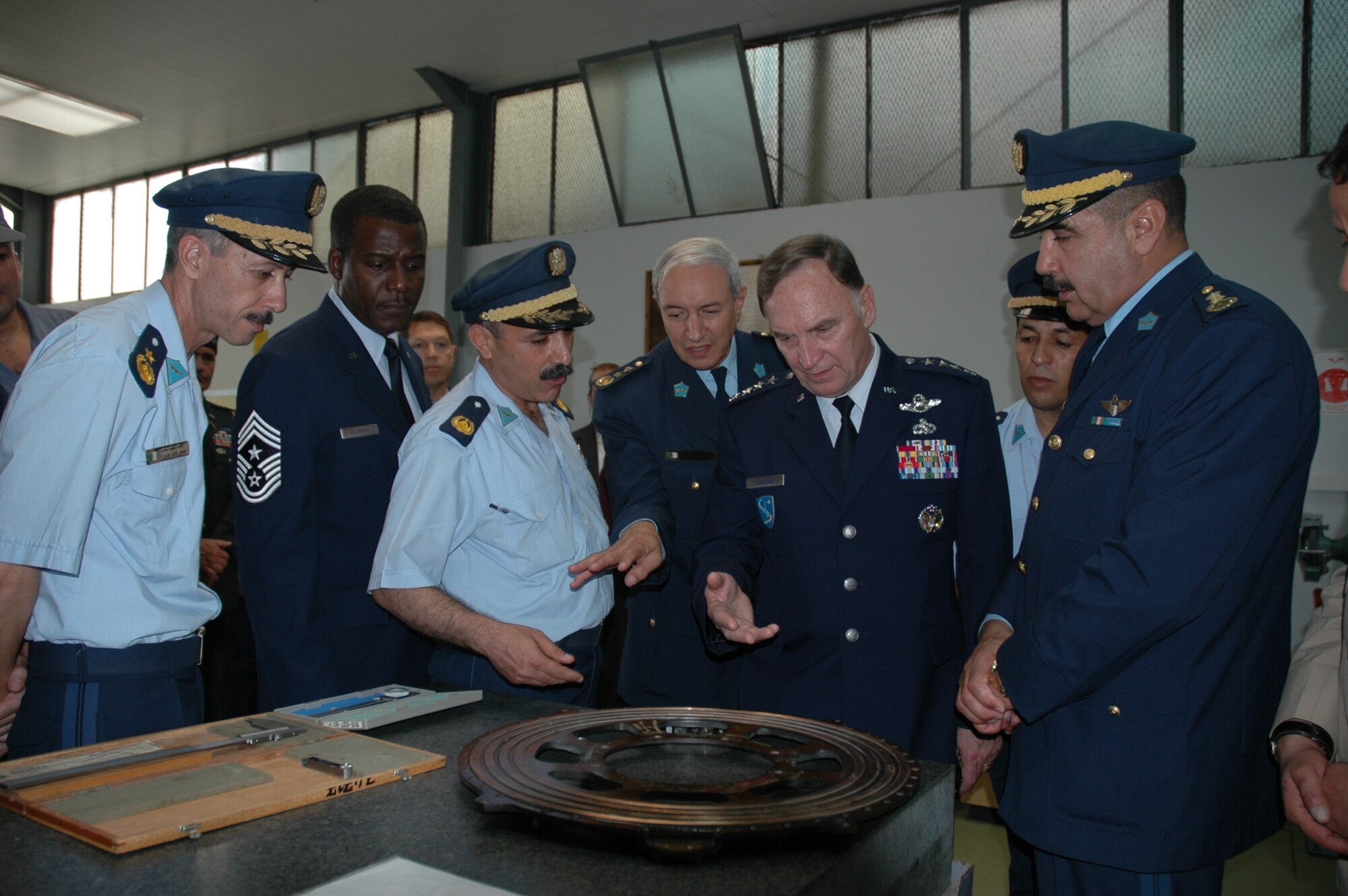 BOUFARIK AIR BASE, Algeria -- General Tom Hobbins, U.S. Air Forces in Europe commander, and Chief Master Sgt. Gary Coleman, U.S. Air Forces in Europe command chief, receive a tour of Boufarik Air Base June 24.  During their visit, they toured the transport aircraft maintenance facility, simulator facility and met Airmen from the Algerian Air Force.  