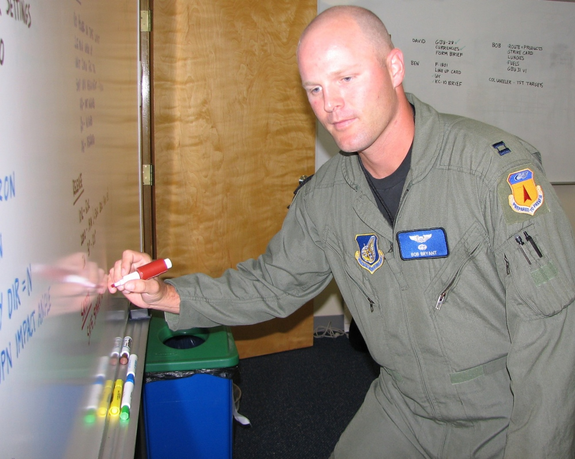 ANDERSEN AIR FORCE BASE, Guam – ‘Mission Planning’ – Captain Bob Bryant, 13th Expeditionary Bomb Squadron B-2 Spirit pilot, adds notes to a mission planning – or “grease” – board in the bomber operations center at Andersen Air Force Base, Guam, July 10. The captain is one of approximately 35 Airmen, from the 13th Bomb Squadron and the 509th Operations Support Staff, Whiteman AFB, Mo., who arrived here June 29-30 for a two-month deployment. The deployment of B-2 aircraft and personnel to Andersen AFB is to provide the U.S. Pacific Command commander a continuous bomber presence in the Asia-Pacific region. (USAF Photo by Tech. Sgt. Mikal Canfield)