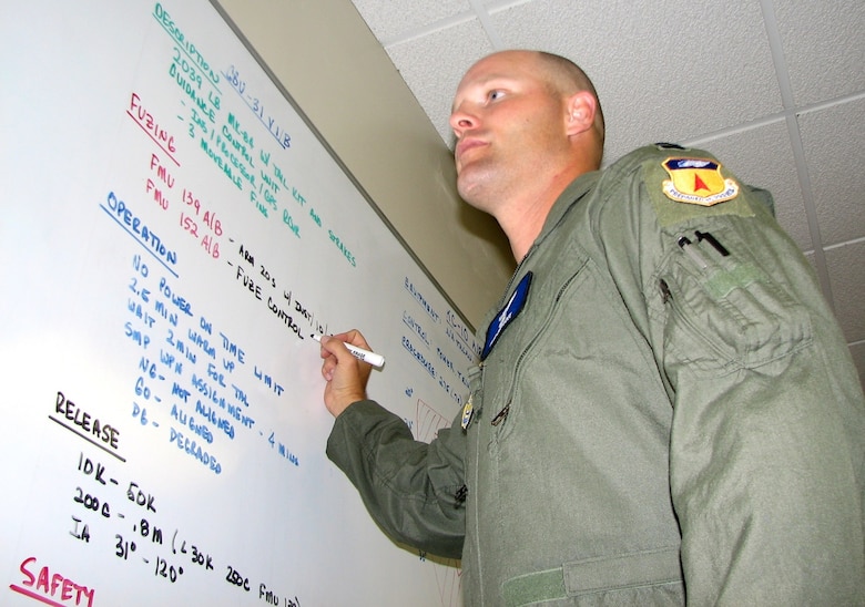 ANDERSEN AIR FORCE BASE, Guam – ‘Mission Planning’ – Captain Bob Bryant, 13th Expeditionary Bomb Squadron B-2 Spirit pilot, adds notes to a mission planning – or “grease” – board in the bomber operations center at Andersen Air Force Base, Guam, July 10. The captain is one of approximately 35 Airmen, from the 13th Bomb Squadron and the 509th Operations Support Staff, Whiteman AFB, Mo., who arrived here June 29-30 for a two-month deployment. The deployment of B-2 aircraft and personnel to Andersen AFB is to provide the U.S. Pacific Command commander a continuous bomber presence in the Asia-Pacific region. (USAF Photo by Tech. Sgt. Mikal Canfield)