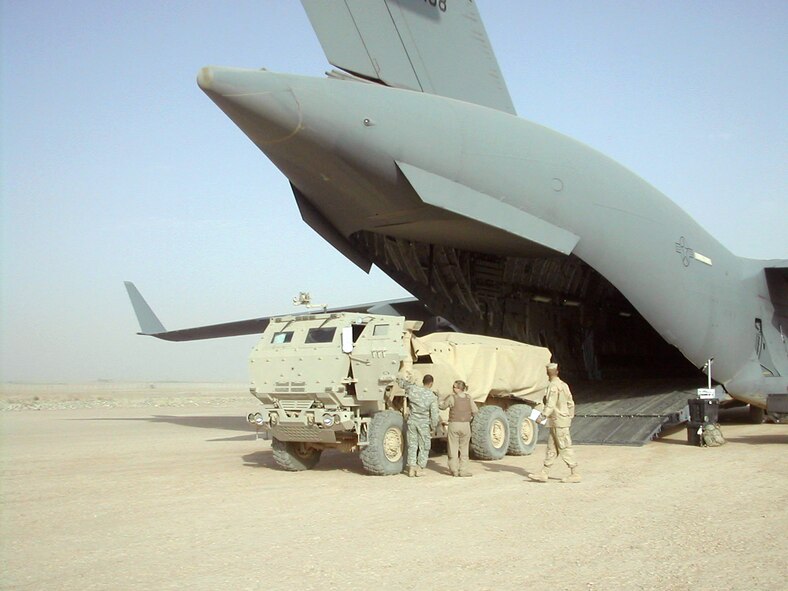 A High Mobility Artillery Rocket System is offloaded from a C-17 Globemaster III onto a dirt landing strip July 3 in Southwest Asia. The C-17 mission re-supplied coalition international security assistance forces in a remote region of Afghanistan. (U.S. Air Force photo/Capt. Krista Staff)