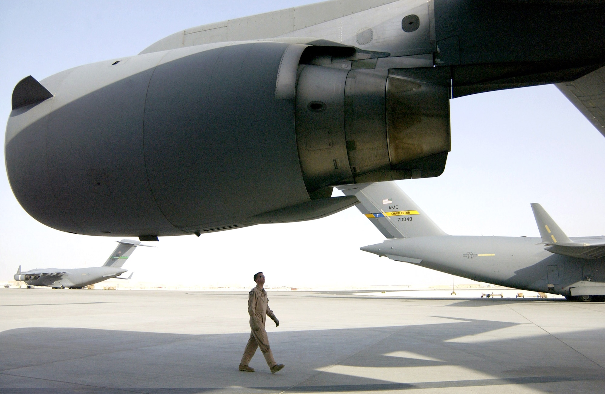 Capt. Pat Farrell performs a preflight check of a C-17 Globemaster III July 3 at a forward operating base in Southwest Asia prior to flying an airdrop mission. Deployed from Charleston Air Force Base, S.C., Captain Farrell is assigned to the 816th Expeditionary Airlift Squadron, one of two C-17 squadrons in the area of responsibility now deploying in rotation periods similar to air and space expeditionary force deployments. (U.S. Air Force photo/Tech. Sgt. Chuck Marsh)