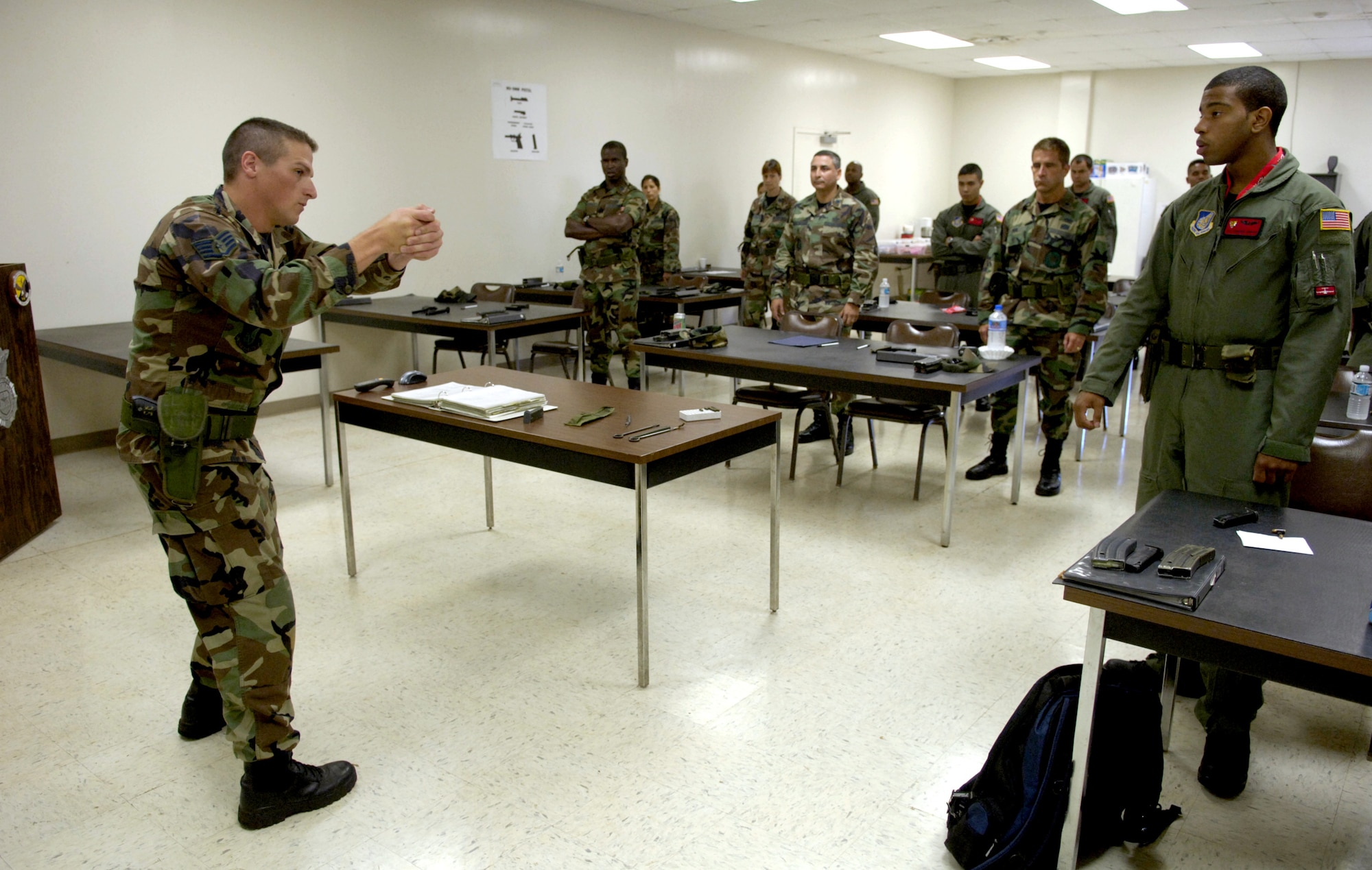 Staff Sgt. Erik Sprague demonstrates proper standing techniques during his small-arms training class at the shooting range at Schoefield Barracks, Hawaii, on July 7. Sergeant Sprague is a combat arms training instructor from nearby Hickam Air Force Base. (U.S. Air Force photo/ Tech. Sgt. Shane A. Cuomo)