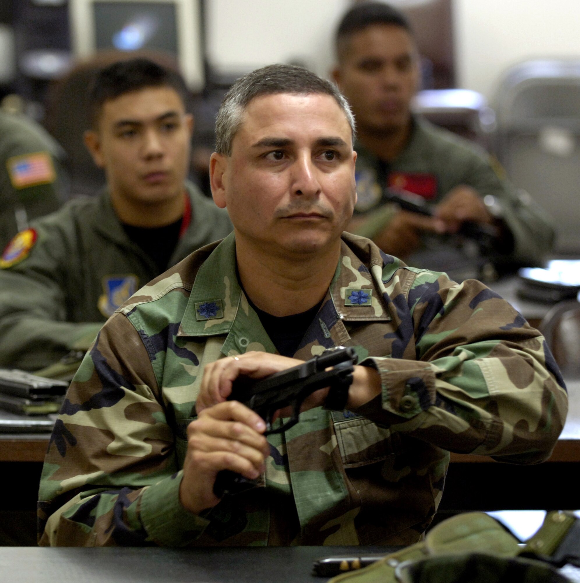 Lt. Col. Daniel Ponce De Leon listens to instruction during a small-arms training class at the shooting range at Schoefield Barracks, Hawaii, on July 7. The colonel is the chief of officer assignments at Pacific Air Forces Headquarters. (U.S. Air Force photo/ Tech. Sgt. Shane A. Cuomo)
