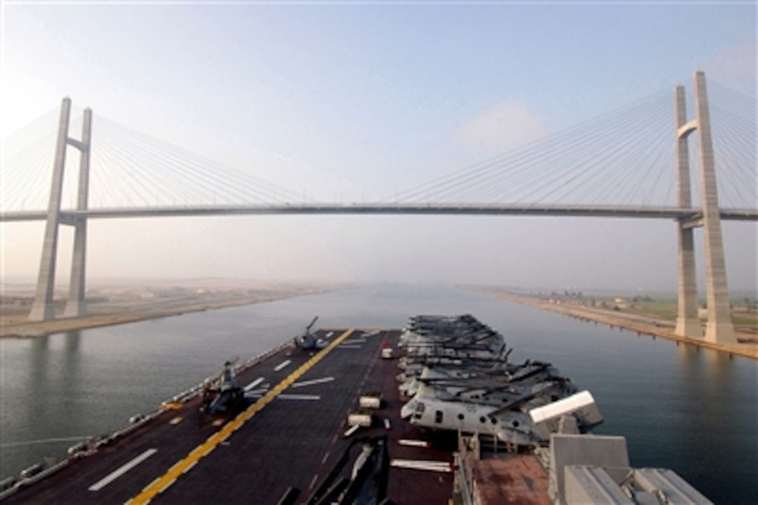 The amphibious assault ship USS Iwo Jima passes the Mubarak Peace Bridge, as the ship transits through the Suez Canal, July 4, 2006. The Iwo Jima is deployed in support of the global war on terrorism and maritime security operations in the region. 
