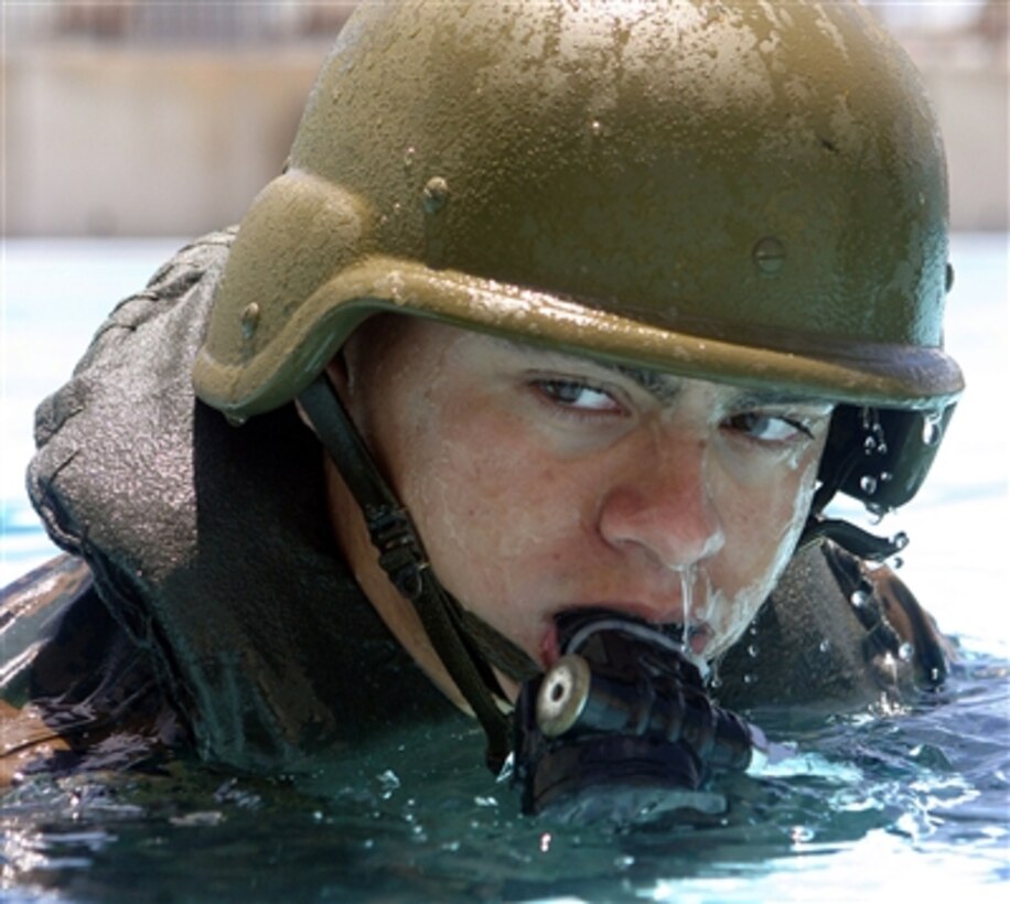 U.S. Marine Corps Pfc. James Rockwell rises from the water during survival training in the Camp Hansen Training Pool, in Okinawa, Japan, June 23, 2006. Rockwell is a field radio operator with the 31st Marine Expeditionary Unit.  