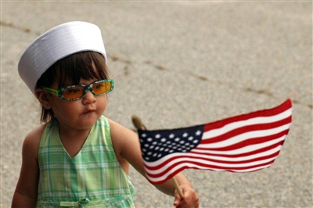 Waiting For Dad 
U.S. Navy Petty Officer 2nd Class Robert M. Garcia's daughter entertains herself by waving the American Flag while she waits for her father to arrive aboard the dock landing ship USS Fort McHenry at Naval Amphibious Base Little Creek, Va., July 6, 2006. The Fort McHenry participated in Joint Caribbean Lion 2006, a Dutch-led exercise off the coast of Aruba and the Netherlands Antilles island of Curacao.
