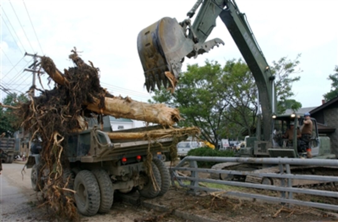 U.S. Army National Guard soldiers clean up fallen trees July 2, 2006, from Walton, N.Y., after severe thunderstorms and flood-like conditions hit the surrounding area. The soldiers are assigned to the New York Army National Guard's 204th Engineering Battalion based out of Binghamton, N.Y. 