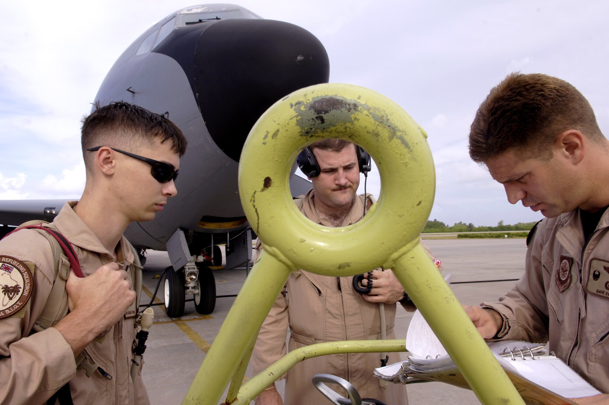(Left to right) Senior Airman Mark Fiorotto, Capt. Brad Post and Lt. Col. David Cohen go over preflight paperwork before boarding their KC-135 Stratotanker for a refueling mission in support of Operation Enduring Freedom. The crew is with the 28th Expeditionary Air Refueling Squadron. (U.S. Air Force photo/Senior Airman Brian Ferguson) 

