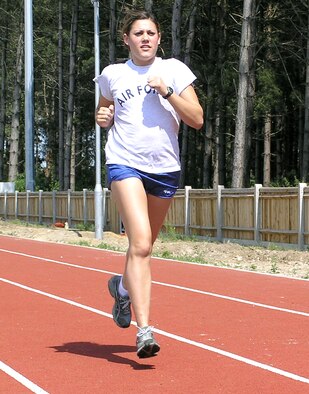 Airman Savanna Duchala runs at Royal Air Force Mildenhall, England, as part of her daily training. Duchala is a member of the Air Force Track and Field Team. She is assigned to the 100th Mission Support Squadron military personnel flight. (U.S. Air Force photo/Karen Abeyasekere)