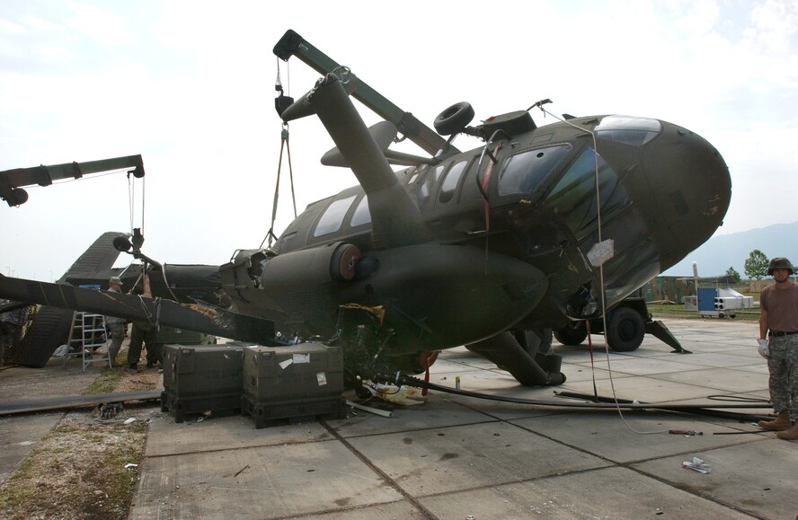 Servicemembers prepare to stabilize an aircraft at Aviano Air Base, Italy, on July 6. The aircraft suffered damage after a severe thunderstorm with wind gusts that measured up to 82 knots. The storm tore through Aviano on June 29, and caused basewide damage estimated at $3.5 million. (U.S. Air Force photo/Airman Liliana Moreno) 