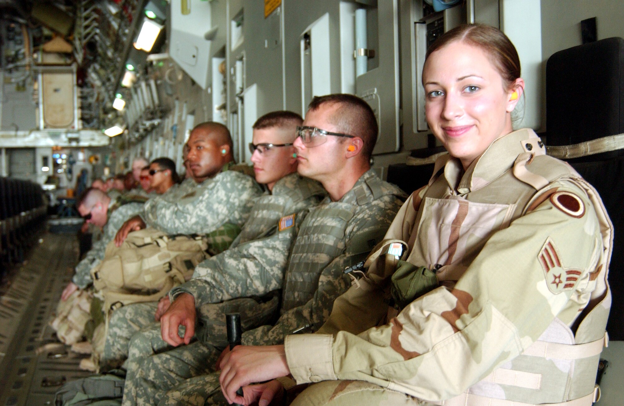 Senior Airman Deanna Marks and several Soldiers await take-off on a C-17 Globemaster III at Sather Air Base, Iraq. Airman Marks is assigned to the 1st Weather Squadron. (U.S. Air Force photo/Master Sgt. Jonathan F. Doti) 