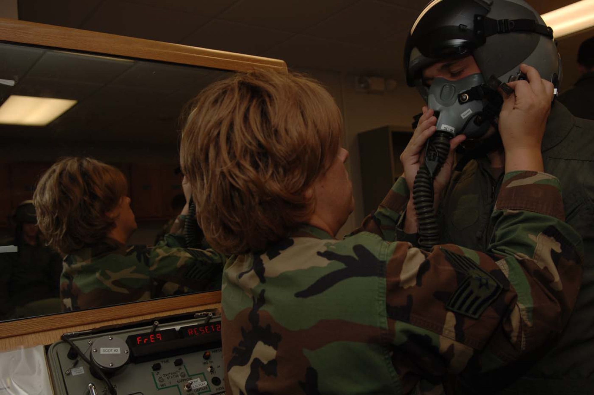 MOODY AIR FORCE BASE, Ga. -- Staff Sgt. Rebecca Blalock, 479th Operation Support Squadron here, adjusts a pilot’s mask on Cadet Joseph Waechter. Forty cadets are currently touring Moody as part of the Operation Air Force Program. (Photo By Airman 1st Class Schelli Howard)