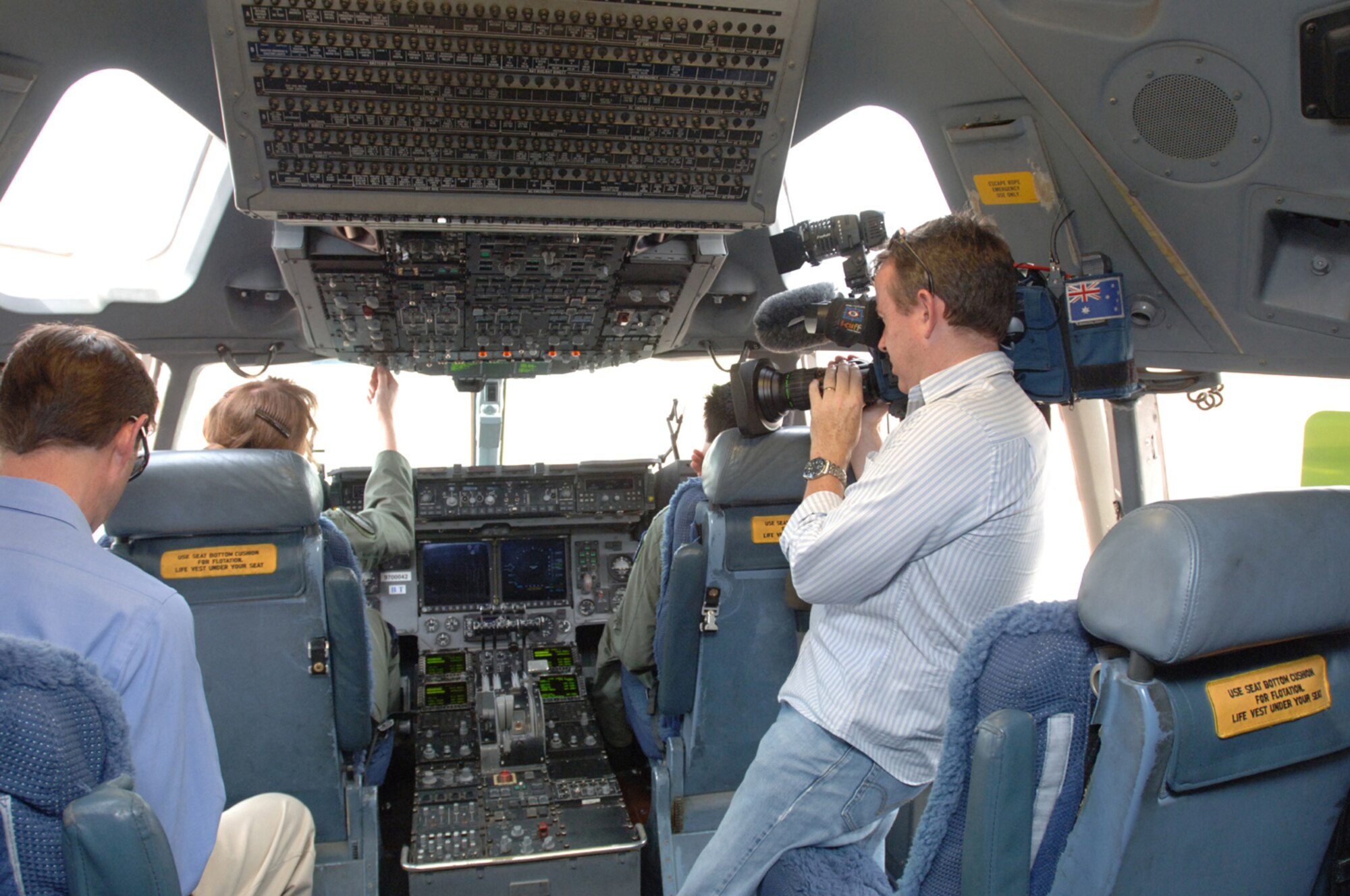 Australian TV Channel 9 reporter and cameraman record Australian aircrew students at the controls of a C-17 at Altus AFB, Okla.