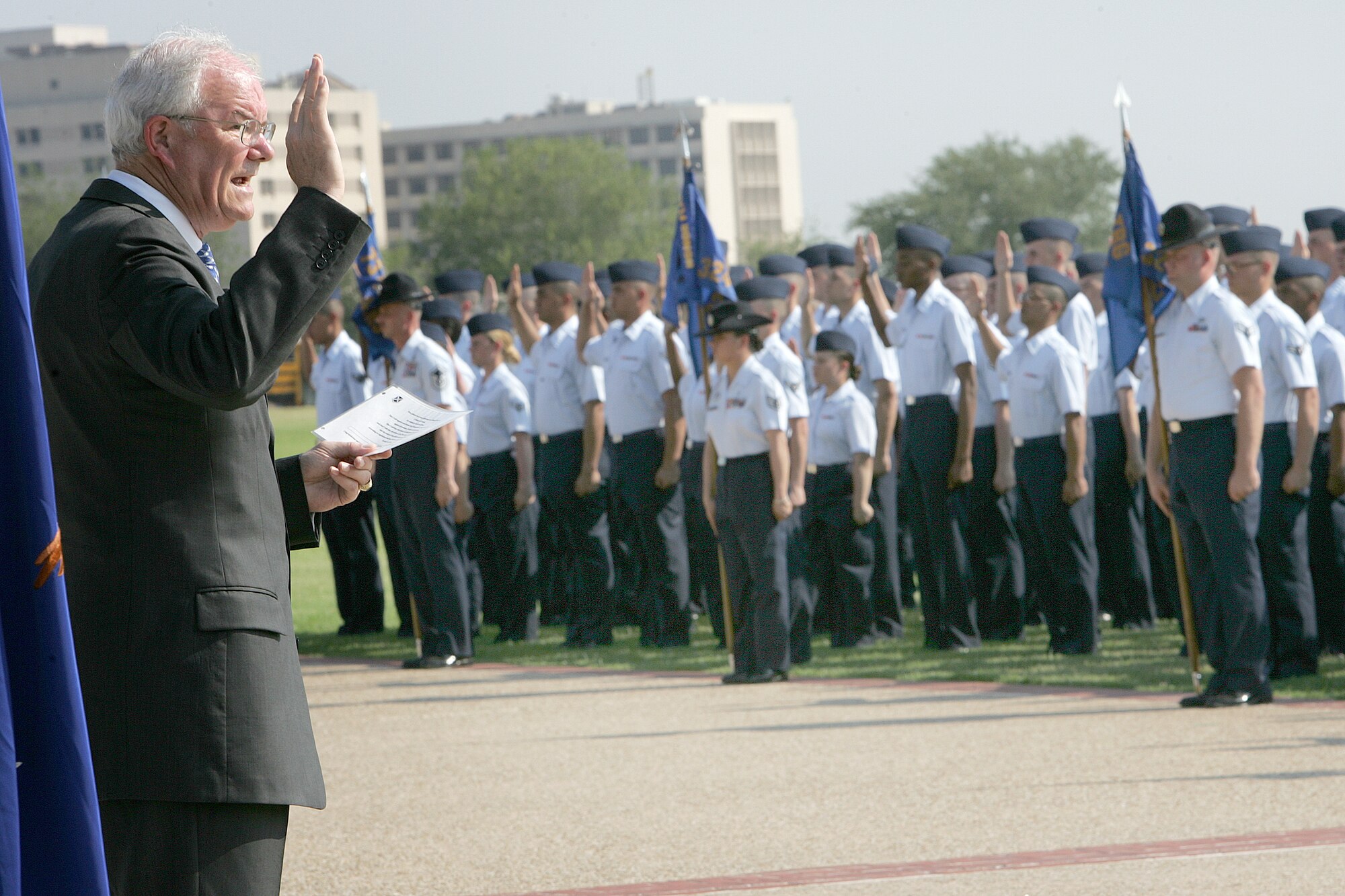LACKLAND AIR FORCE BASE, Texas (AETCNS) -- Secretary of the Air Force Michael Wynne gives the Oath of Enlistment to newly graduated Airmen at a Basic Military Training graduation parade here June 2. In addition to reviewing the parade, Secretary Wynne also observed a culmination exercise at Lackland’s Field Training Site and toured a Basic Military Training dormitory.
