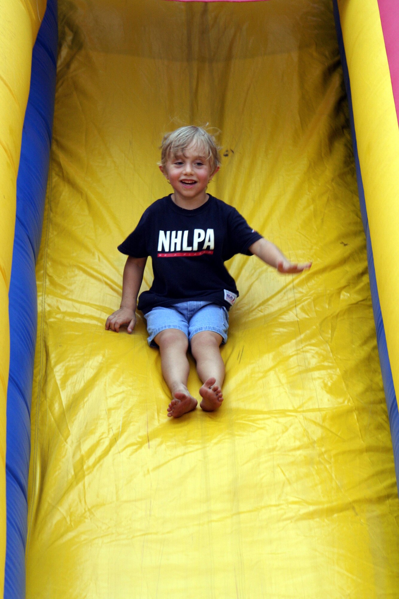 Boy slides down slide at Sound of Independence July 1. (U.S. Air Force Photograph by Staff Sgt. Kelly Ogden)