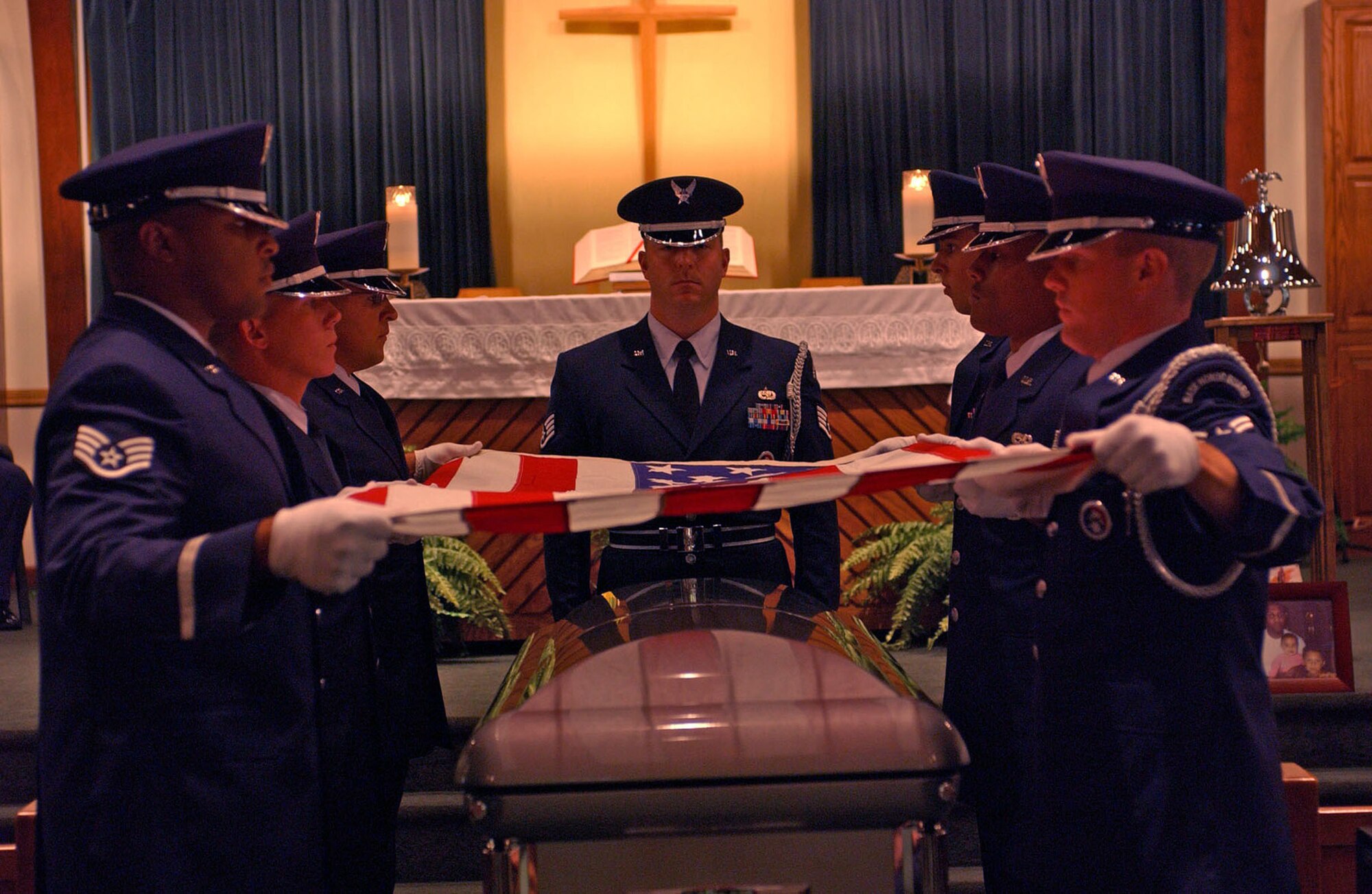 Members of the Hurlburt Field Honor Guard fold the flag over the casket of Tech. Sgt. Earnest  Rockamore, 16th Civil Engineer Squadron, during a memorial service here June 29. (U.S. Air Force Photograph by Senior Airman Kimberly Batts.)