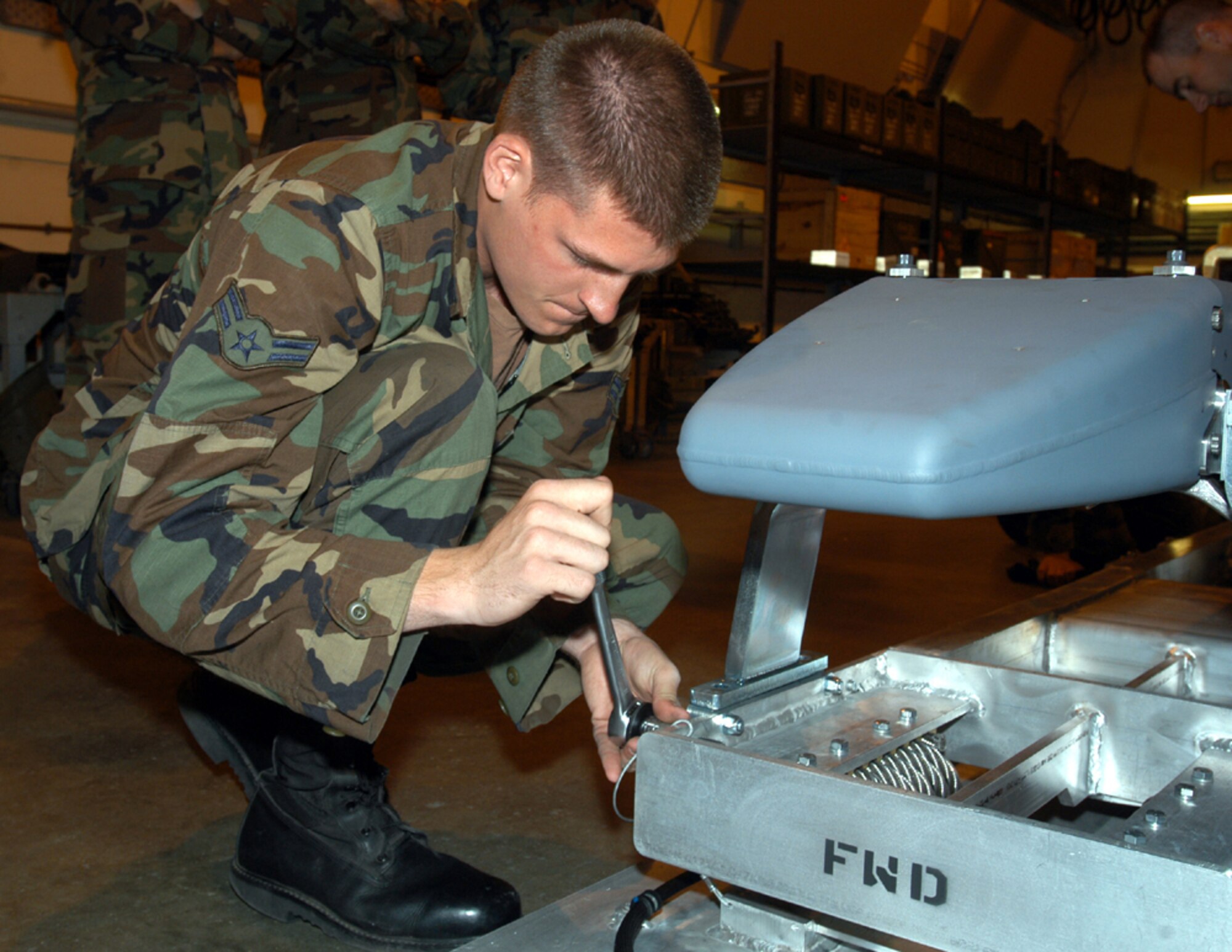 ROYAL AIR FORCE LAKENHEATH, England -- Airman 1st Class Mark Sturtevant, 48th Munitions Squadron conventional maintenance crew member, trains on the new munitions release unit here June 27. This is the first time the Airmen conducted operational training on the munition for their scheduled deployment in September.
(Photo by Airman 1st Class Michael Hess)