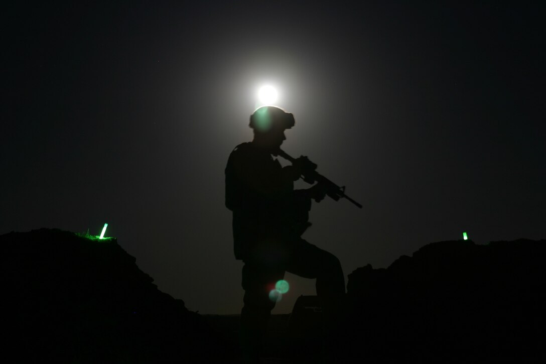 Sgt. Brandon N. Quiter, 24th Marine Expeditionary Unit, scans the moonlit horizon from the perimeter of his camp July 11. The 24th MEU is currently conducting bilateral training in the Central Command theater of operation. Quiter, 25, is an Everett, Wash., native and a force protection specialist with the 24th MEU command element.